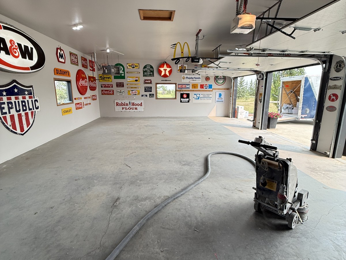 Bare concrete floor before coating, same garage